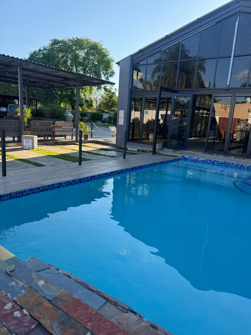 Pool area at Monet Guesthouse at night
